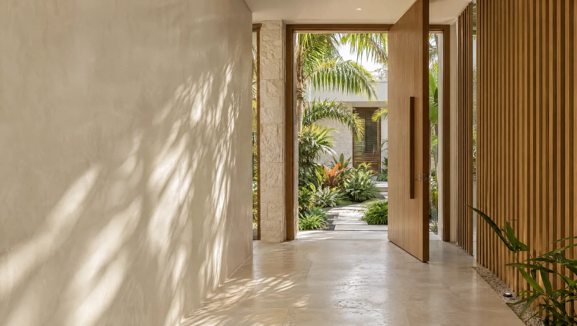 Concept photograph of a finished tropical courtyard passage with timber screens and precise stone finishes