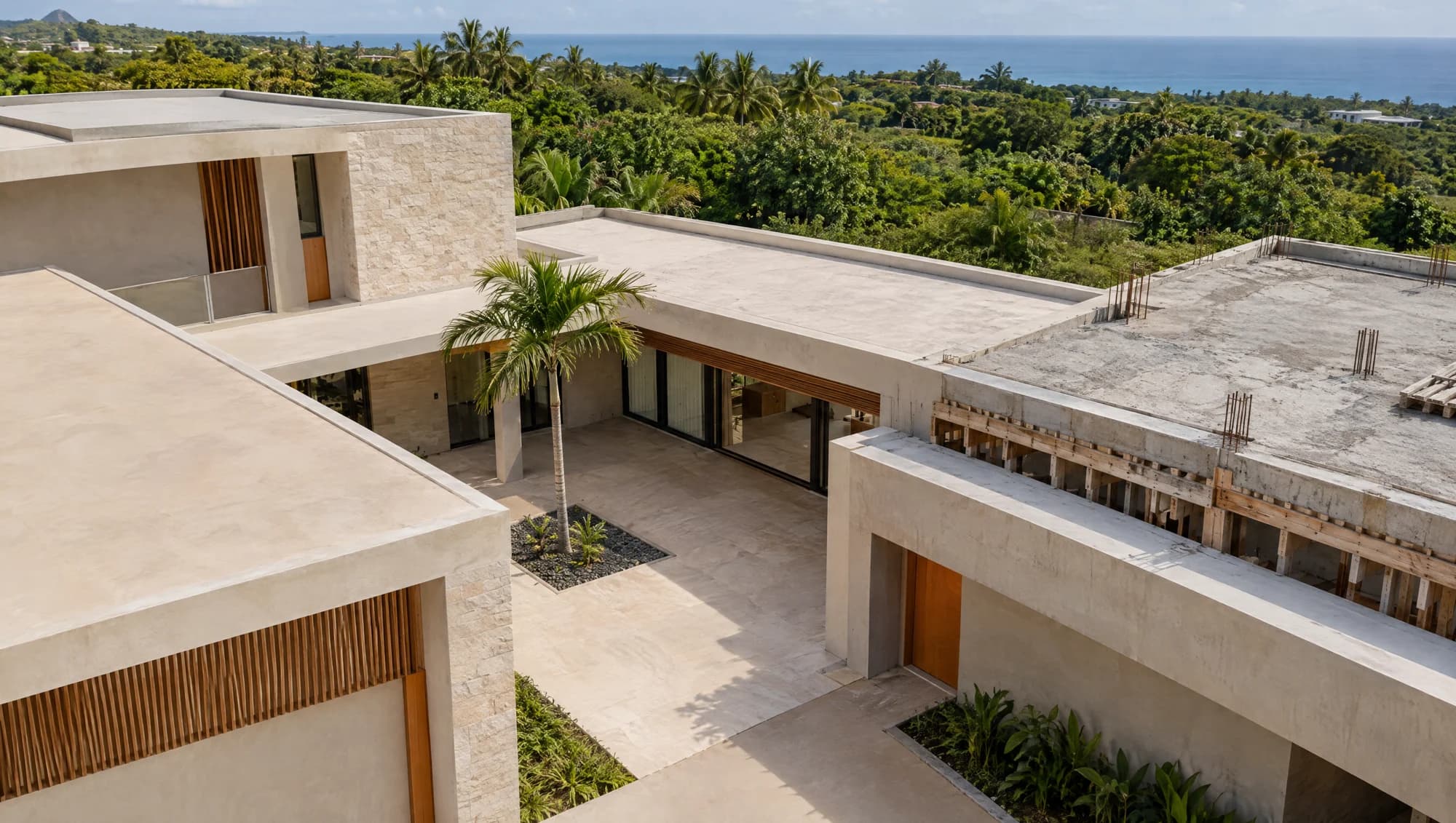 Illustrative aerial view of a tropical courtyard home with finished and unfinished construction elements